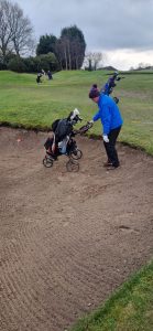 Phil Mac Raking Bunker with His Trolley