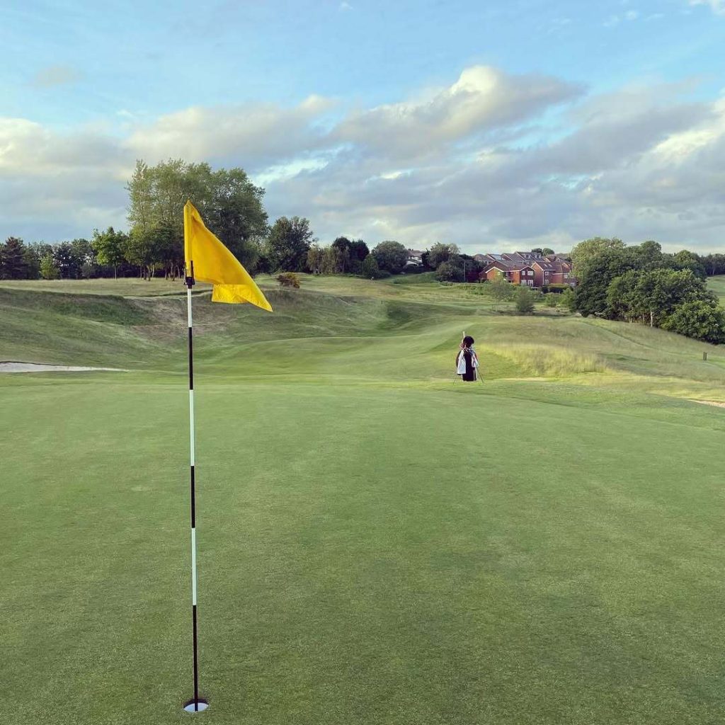 Yellow flag with bunkers guarding the green